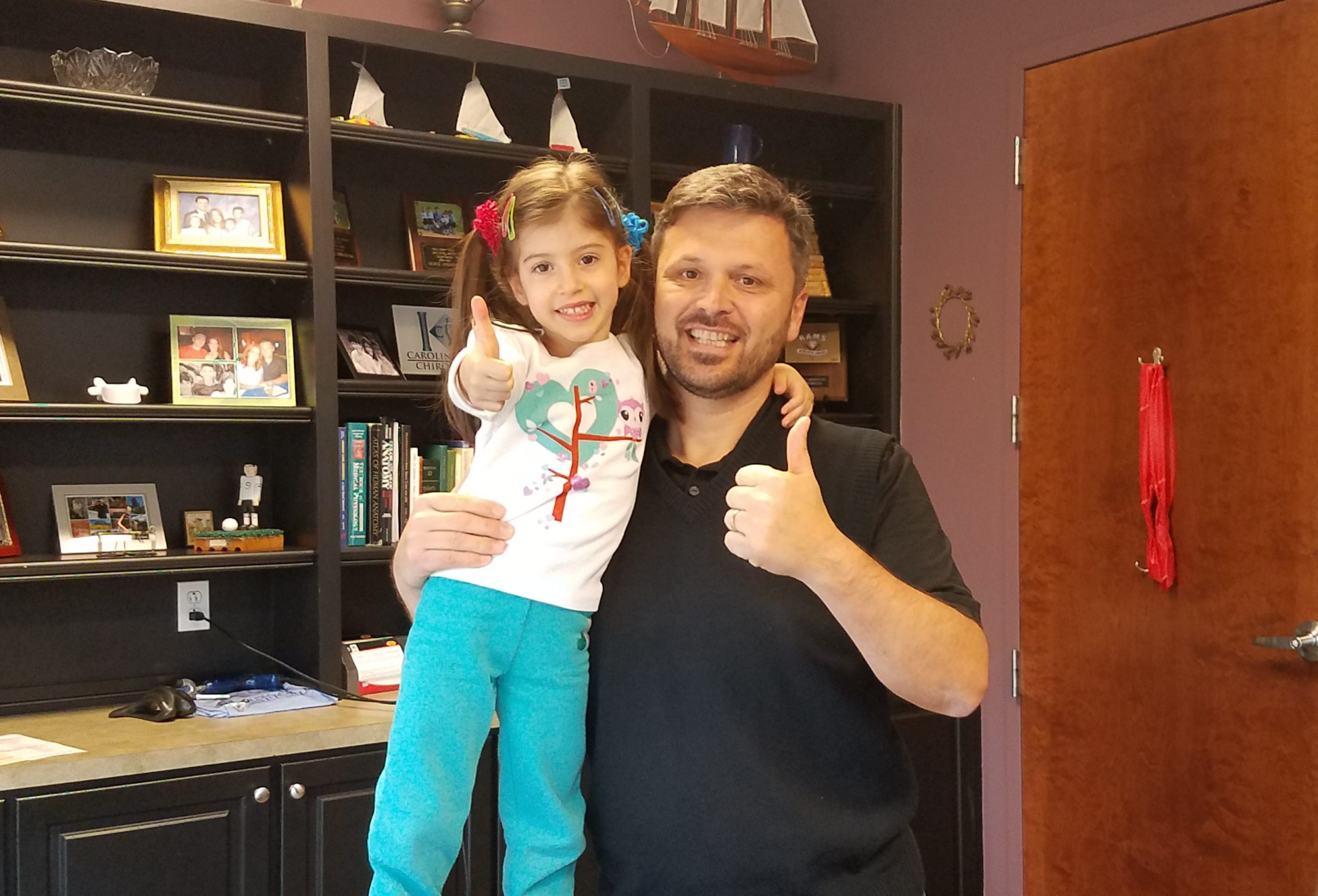 Dr. George Limbanovnos with a patient showing a thumbs up sign